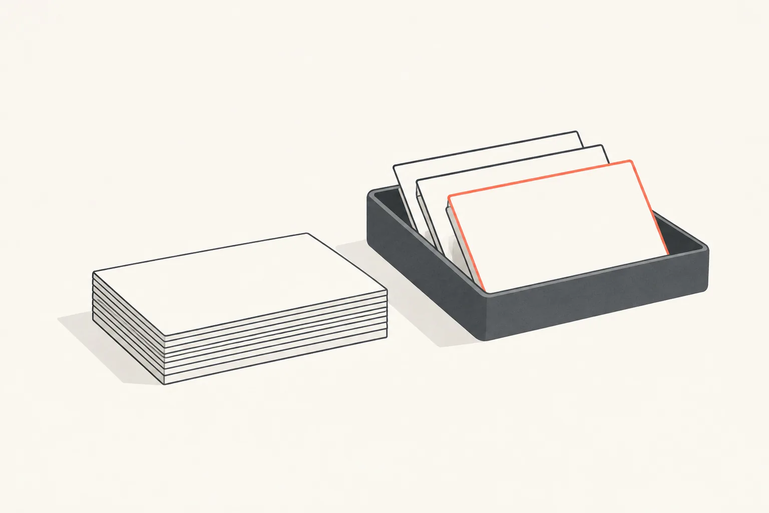 A tidy short stack of index cards on a desk beside a tray holding a few parked cards, one card outlined in coral.